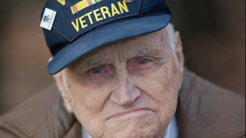 Bill Knight poses in his yard before going to the airport to greet returning troops