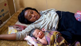 Hi Sokha and her baby in Kratie, Cambodia Hi Sokha and her baby in Kratie, Cambodia