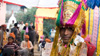 Hari poses wearing his wedding turban with guests in the background.