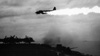 Japanese plane ablaze over escort carrier