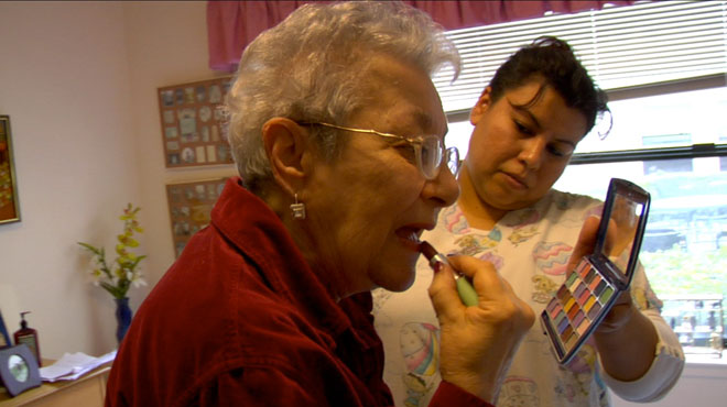 Lee Gorewitz applying lipstick. 