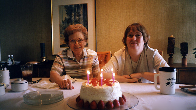 mother and daughter Mimi and Dona with birthday cake